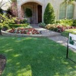 A house with a lawn that has been cut in half.