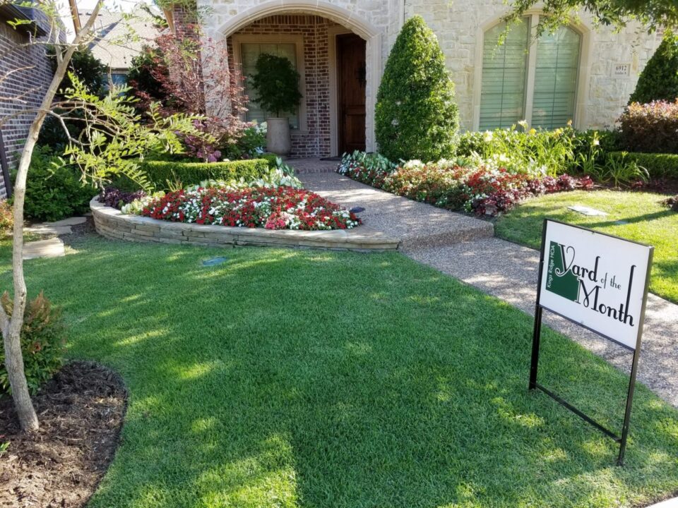 A house with a lawn that has been cut in half.